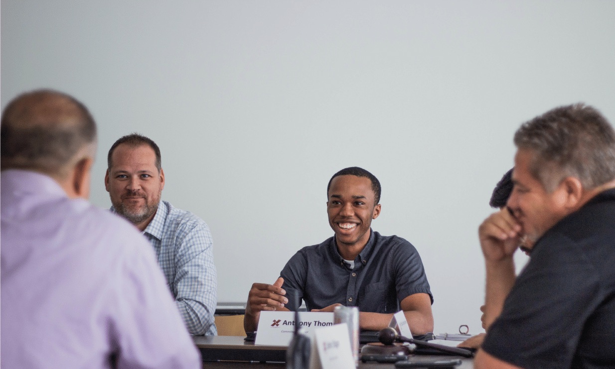 Board members speaking at a board meeting.